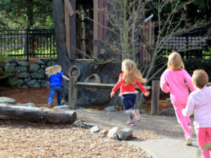 Children running in nature play environment